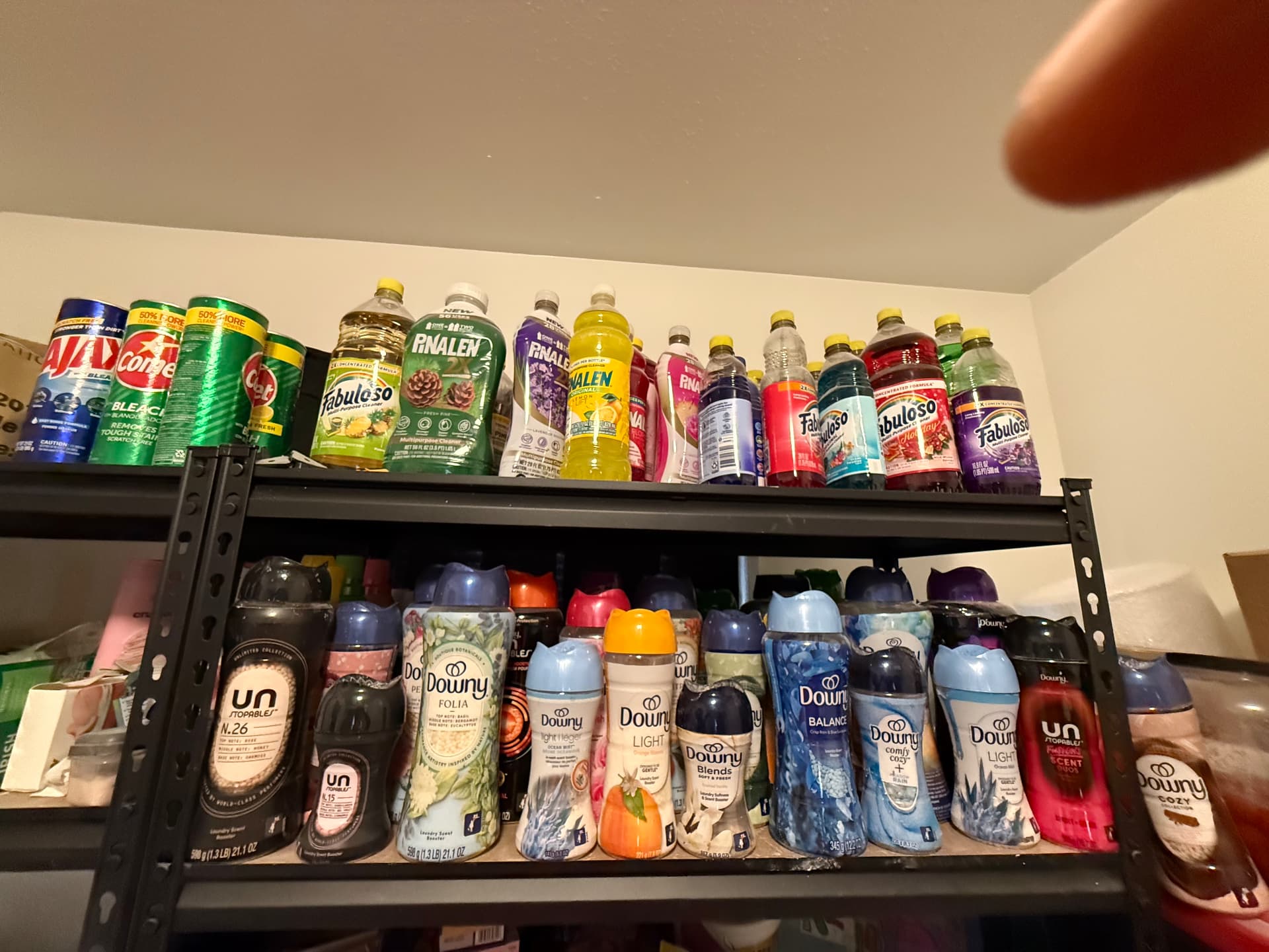 Shelves of multi-purpose cleaners and Downy scent beads